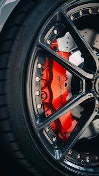 Detailed shot of a Lamborghini brake disc with red brake caliper, showcasing luxury and precision.